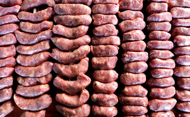 Raw sausage on barbecue skewers