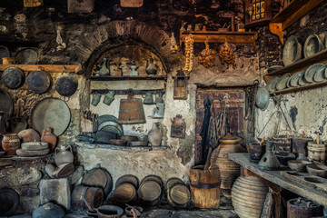 Old ancient Meteora monastery dining room interior entirely filled with kitchen utensils and manual cookery equipment 