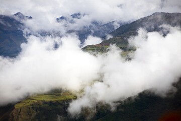 Village and terraced field in the middle of clouds peru