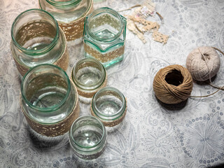 Cozy handmade holiday home decor, glass jars decorated white ribbon.