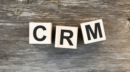 CRM, Customer Relationship Management, loyalty program, repeat purchase frequency concept, cube wooden block with alphabet combine the word abbreviation CRM on light coloured background.