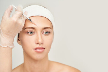 Forehead injection at spa salon. Doctor hands. Closeup. High quality. Pretty female patient. Beauty...