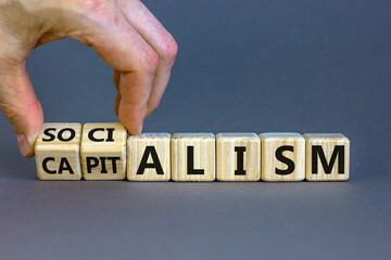 Capitalism or socialism. Hand turns cubes and changes word 'capitalism' to 'socialism'. Beautiful...