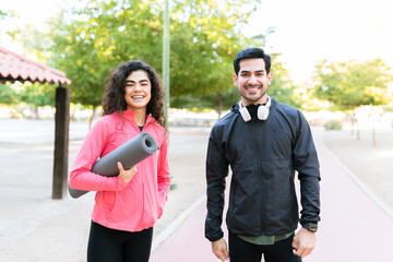 Portrait of a happy couple ready for working out in the park