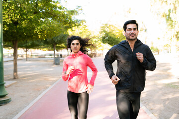 Focused couple on jogging in the running track