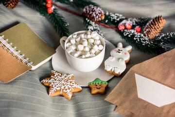 Christmas Cup of cocoa with marshmallows, delicious New Year's cookies on w bed. Winter concept. Cozy sweet home. Nobody Indoor.