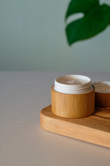 Natural moisturizing cream in eco-friendly bamboo jar. Organic skin care product packaging design
