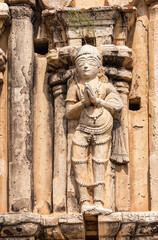 Hampi, Karnataka, India - November 4, 2013: Virupaksha Temple complex. Closeup of praying woman on south side of east Gopuram. 