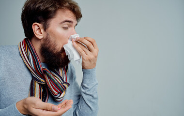 a man with a cold wipes his nose with a handkerchief health problems pills medicine - obrazy, fototapety, plakaty