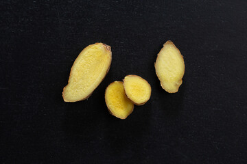 Whole ginger chunks on dark background