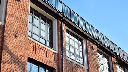 Beautiful facade of a modern office building made of red brick.