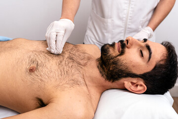 Obraz na płótnie Canvas Man lying in stretcher receiving a treatment.
