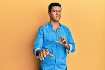 Young arab man wearing casual clothes disgusted expression, displeased and fearful doing disgust...