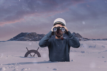 shipwrecked helmsman watching with binoculars the mountain and stuck in snow