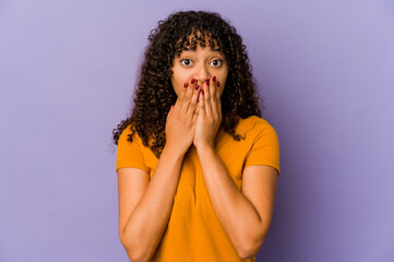 Young african american afro woman isolated shocked, covering mouth with hands, anxious to discover something new.