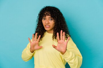 Young african american afro woman isolated rejecting someone showing a gesture of disgust.