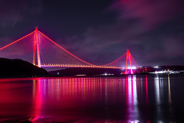Fototapeta na wymiar Panoramic view of the Yavuz Sultan Selim Bridge with backlit in Istanbul, Turkey. Night time. Third Istanbul bridge.