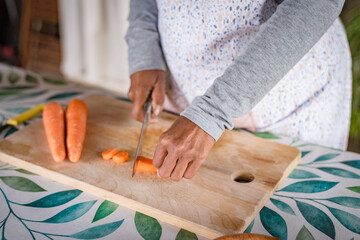 black woman with glasses teaches online with her mobile phone cooking classes from home