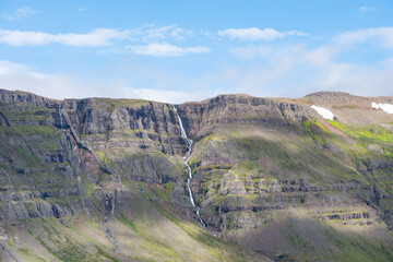 Magnificent waterfall in Brediddalur mountain valley in Iceland