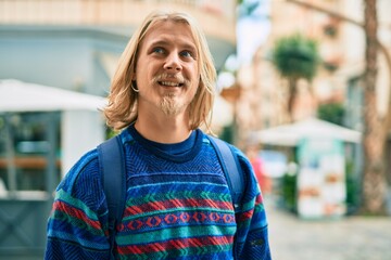 Young scandinavian student man smiling happy standing at the city.