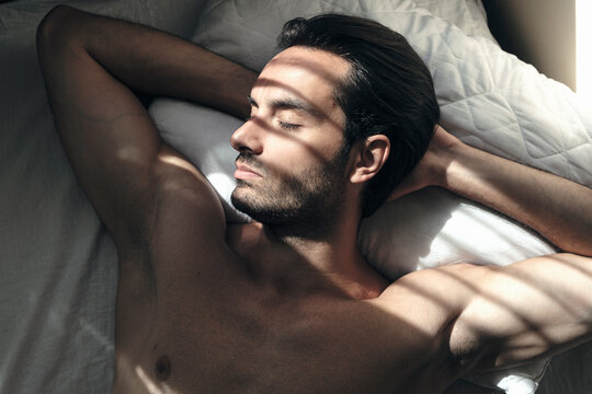 Muscular young man resting in the morning