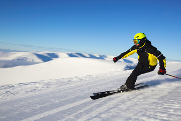 Fototapeta na wymiar Skier skiing downhill in mountains