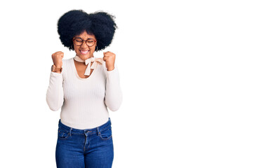 Young african american girl wearing casual clothes and glasses excited for success with arms raised and eyes closed celebrating victory smiling. winner concept.