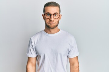 Young caucasian man wearing casual clothes and glasses depressed and worry for distress, crying angry and afraid. sad expression.
