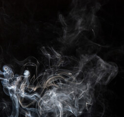 Abstract puffs of smoke on a black background.