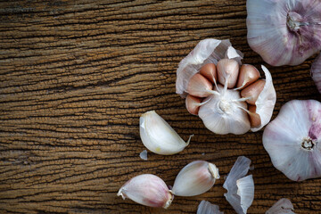 Organic garlic cloves and bulb on wooden table