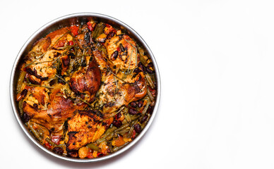 Mexican food chicken with vegetables in a metal dish.