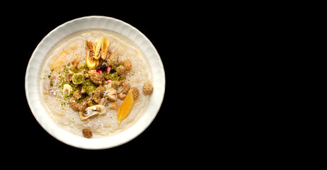 Closeup of traditional Turkish Dessert Asure or Ashura (aka Noah Pudding) in white bowls isolated on black backgroun