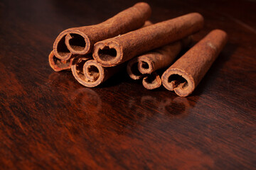 Cinnamon quills sticks on a wooden background