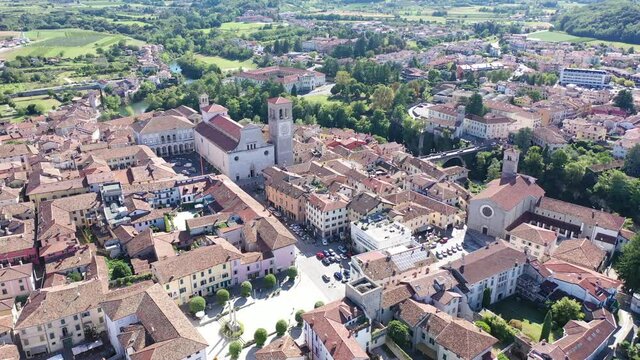Aerial view of Cividale del Friuli cityscape on banks of Natisone river overlooking Catholic cathedral and ancient bridge Ponte del Diavolo, Italy