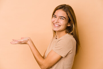Obraz premium Young skinny caucasian teenager girl holding a copy space on a palm.