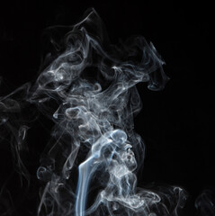 Abstract puffs of smoke on a black background.
