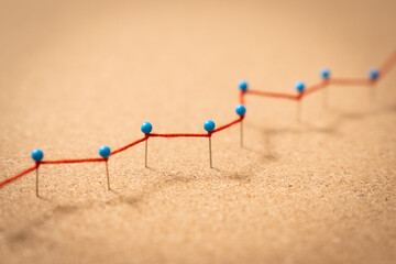 Close up of red growing line in chart as sign of positive business growth, improving