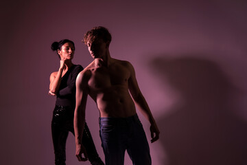 Beautiful happy couple. Couple love. Studio photo. Light. Background. Sensual. Man and woman posing. Fashion. People. 