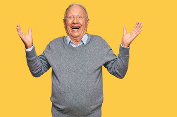 Senior caucasian man wearing casual clothes celebrating victory with happy smile and winner expression with raised hands