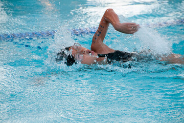 Female child swimming freestyle at a swim meet