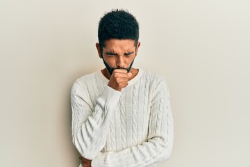 Handsome hispanic man with beard wearing casual winter sweater feeling unwell and coughing as symptom for cold or bronchitis. health care concept.