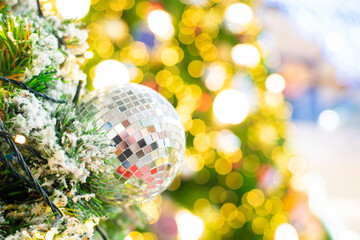 Close up of colorful balls on christmas tree. bokeh garlands in the background.