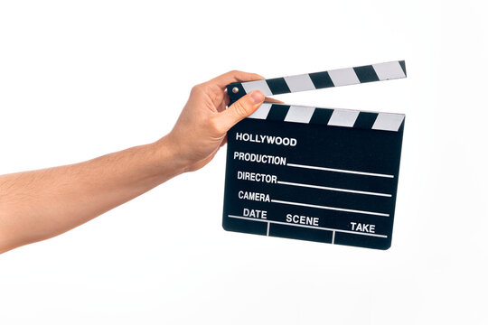 Hand of caucasian young filmmaker man holding clapboard over isolated white background