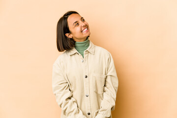 Young hispanic woman isolated relaxed and happy laughing, neck stretched showing teeth.