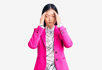 Young beautiful chinese woman wearing elegant clothes suffering from headache desperate and stressed because pain and migraine. hands on head.