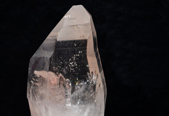 Lemurian Quartz crystal Point from Brazil isolated on a black background.