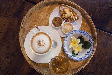 Cappuccino coffee served in a Thai style coffee shop