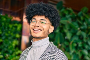 Young african american businessman smiling happy standing at the city.