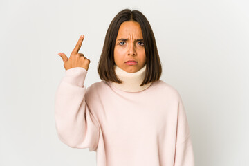 Young hispanic woman wearing a collar showing a disappointment gesture with forefinger.
