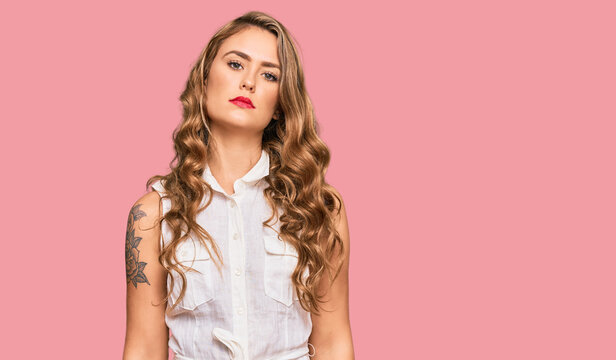 Young blonde girl wearing casual clothes relaxed with serious expression on face. simple and natural looking at the camera.